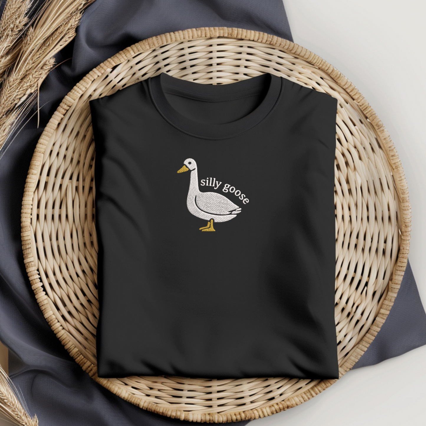 Black t-shirt with a goose graphic and 'silly goose'  embroidery